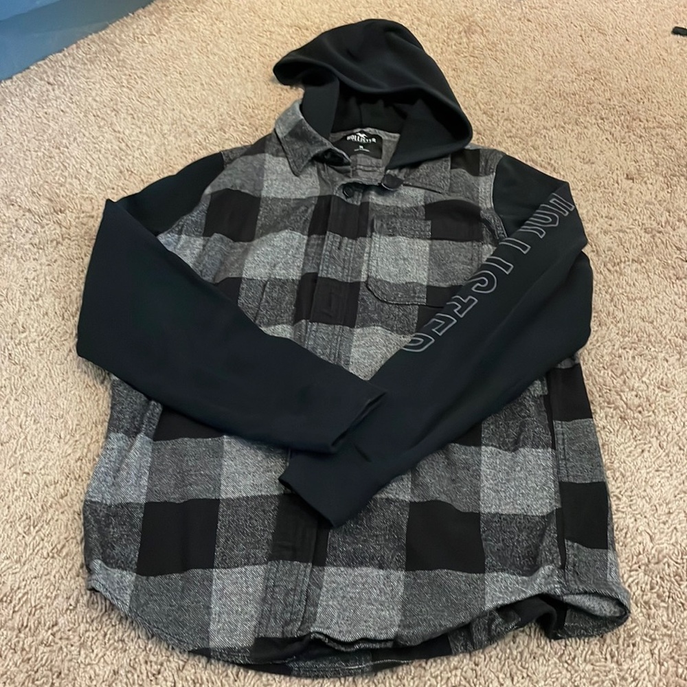 Hollister flannel/hoodie black snd grey plaid says Hollister on left sleeve